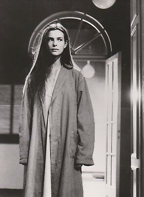 Photographie noir-blanc d'une jeune femme debout dans le couloir d'un asile